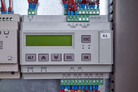 Electric programmable controller for automation of technological processes in the production. Device with LCD display and control buttons.の写真素材