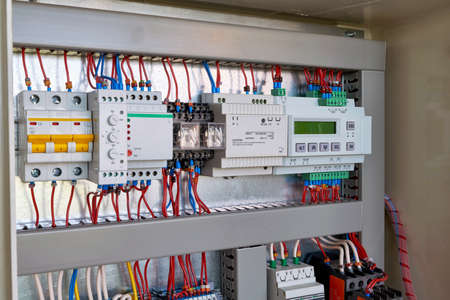 The display controller, power supply, relays, phase control, relay, automatic switch, level switch mounted in series in the electrical Cabinet.の写真素材