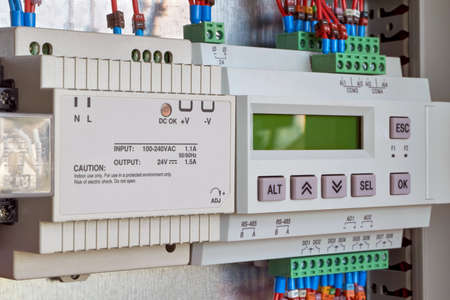 Power supply and controller for remote control in electrical Cabinet. Programmable relay with control buttons and display. Production automation, remote access and control.の写真素材