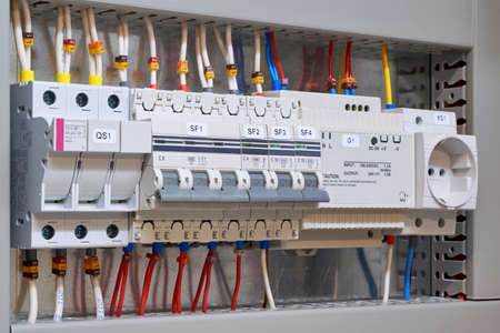 Fuse holder and breaker, circuit breakers, power supply and socket in the electrical Cabinet. Marked wires and cables are connected to electrical equipment. Protection of the electrical network.の写真素材