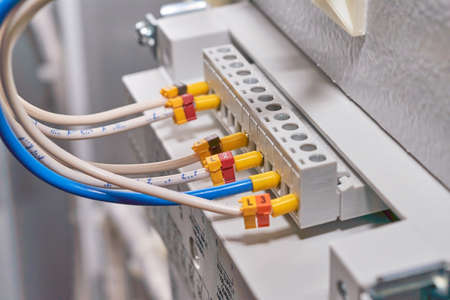 A series of multiple wires connected to an operator panel or remote control device in an electrical Cabinet. The wires are marked with numbers and letters. Electrical equipment and technologies.の写真素材