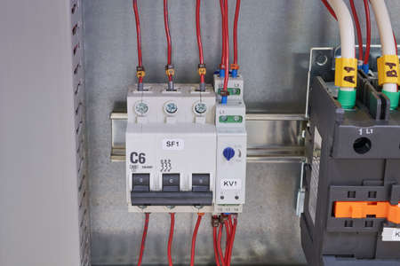 Modular circuit breaker, adjustable phase control relay and contactor or magnetic starter in the electrical Cabinet. Marked wires and cables are connected to electrical equipment.の写真素材