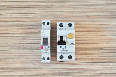 Two electric differential circuit breakers in different versions, single-module and two-module. One narrow, the other wide. Compact version. Protection of a person from electric current.の写真素材