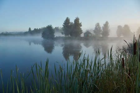 Fishing on the lake. Reflection in water. Recreation center. August 2021.の写真素材