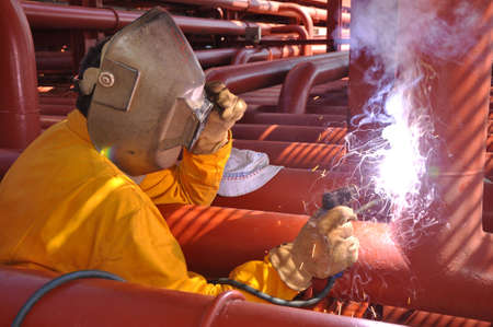  welder works on deck of chemical tanker