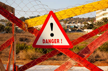 road sign with warning symbol and inscription DANGER