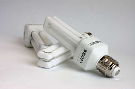 Three energy saving light bulbs on a white background