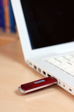 Red USB flash drive inserted into the laptop