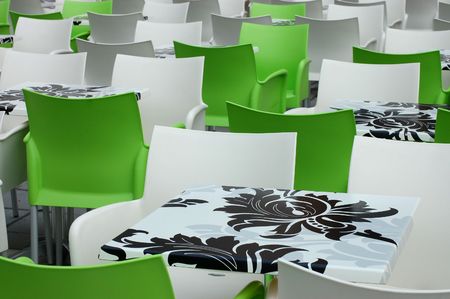 White and green chairs and painted tables in the terrace of the cafeの写真素材