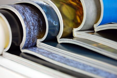Big stack of open color magazinesの写真素材