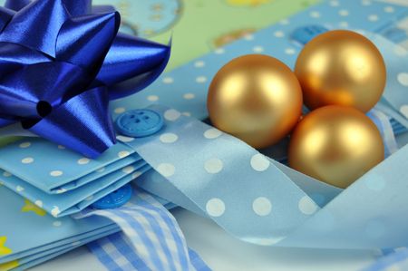 Blue bow and Christmas balls on colorful gift bagsの写真素材