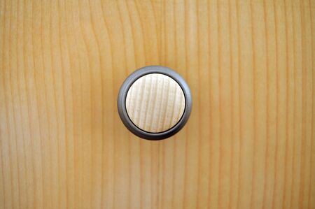 Round door knob on a wooden drawerの写真素材