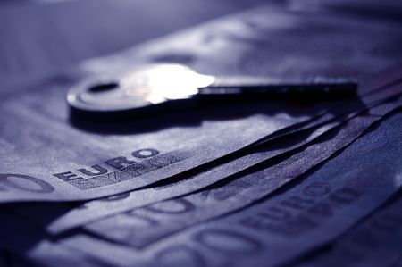 Shiny key on money in blueの写真素材