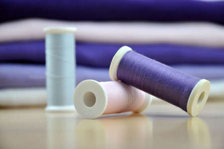 Three spools and a pile of clothesの写真素材