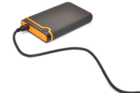 Black and orange portable storage disk, isolated on white