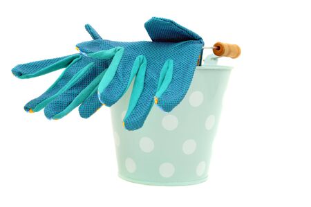 Garden gloves in the blue spotted bucket, isolated on white