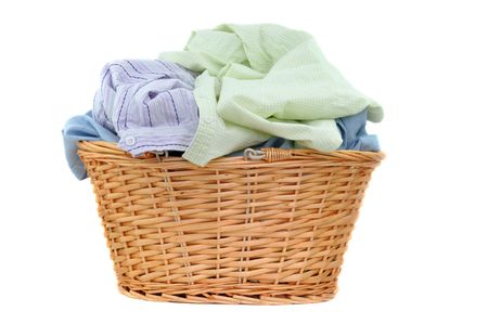 Laundry in a wicker basket, isolated on white の写真素材
