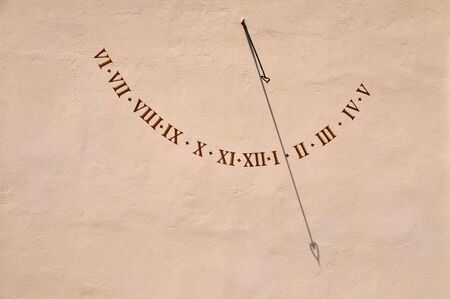 An old-fashioned sun dial on a wall