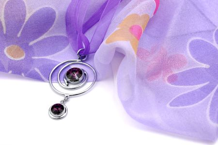 Purple swarovski crystal necklace and floral scarf, isolated on whiteの写真素材