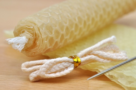 Beeswax handmade rolled candle, wick, honeycomb, and needleの写真素材