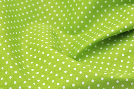 Green polka dot fabric in full frameの写真素材