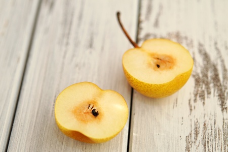 Halved nashi pear on a wooden tableの写真素材
