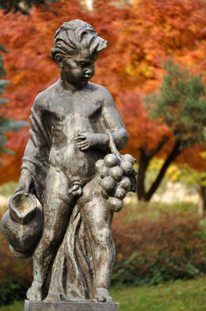 Boy with grape and jug - statue in the Maribor parkの写真素材