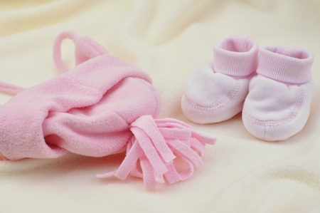 Warm pink baby booties and hatの写真素材