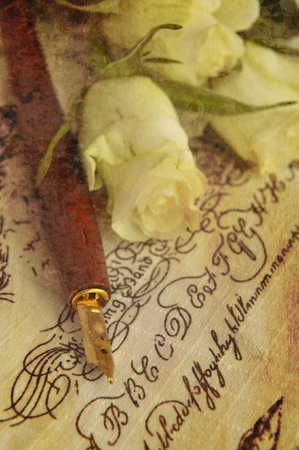 Fountain pen and white roses on handwritten words, toned sepiaの写真素材