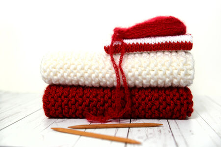 Pile of hand knit Christmas clothesの写真素材