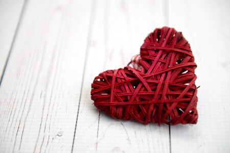 Red heart on a wooden tableの写真素材
