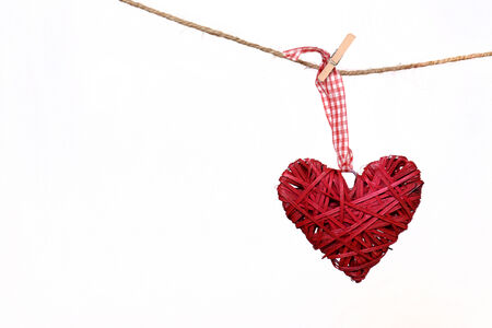 Red heart hanging on a clothesline