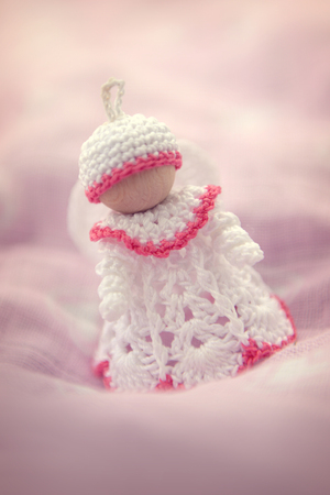 Tiny handmade crochet angel decorationの写真素材