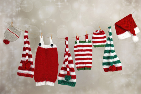 Christmas handmade baby pants and hats hanging on a clotheslineの写真素材