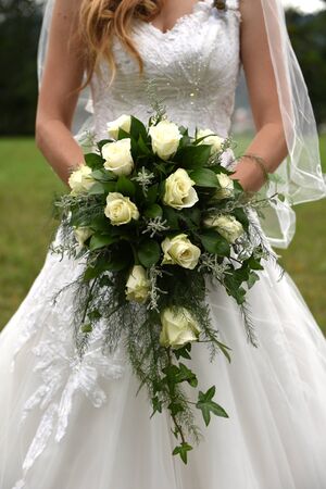 Bride holding cascading bridal bouquetの写真素材