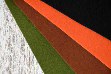 Felt sheets in fall colors on white tableの写真素材