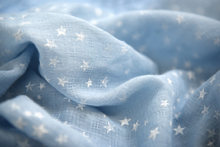 Light blue fabric with white stars in full frameの写真素材