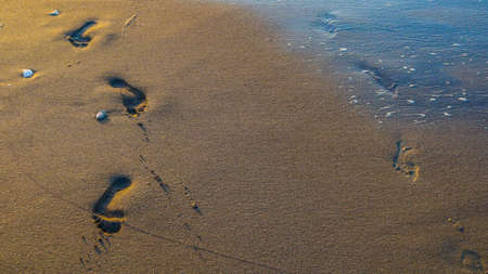 Footprints in the sand during sunrise, Finike Antalya, Turkey. Shoot in July 2018