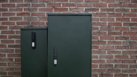 Electric distribution box isolated green brick wall empty mockupの写真素材
