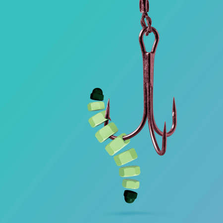 Mechanical Worm made out of nuts on a hook. Toughness of creatures that were here long before us.の写真素材
