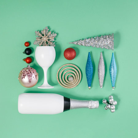 Celebrating Holydays. Modern and trendy square flat layout composition made of christams baubles and other decorations on a pastel green background.の写真素材