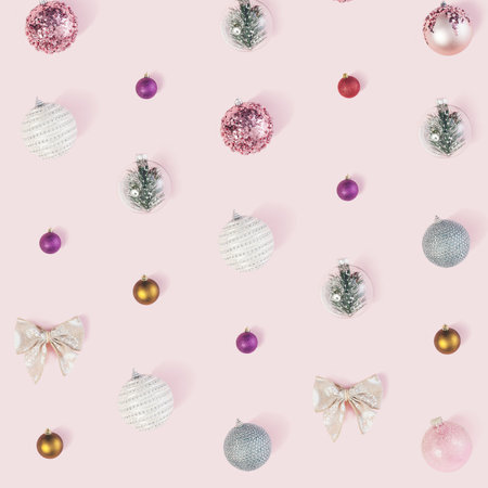 Celebrating Holydays. Flat layout pattern of various christmas decorations on pastel pink background.の写真素材