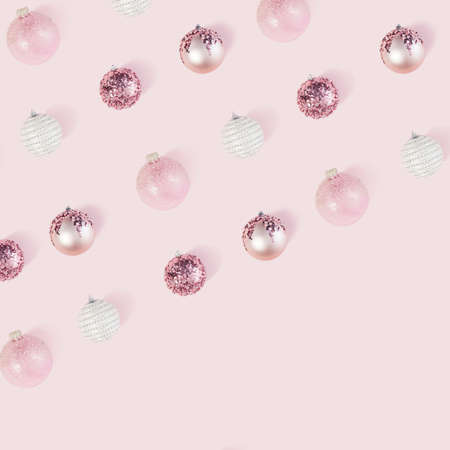 Celebrating pastel pink Holydays. Flat layout pattern of christmas baubles with copy space.の写真素材