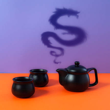Chinese New Year composition with teapot, teacups and steamy shadow dragon.の写真素材