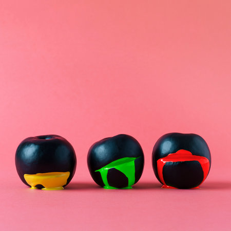 3 haloween sliced black apples bleeding colors on simple backgroundの写真素材