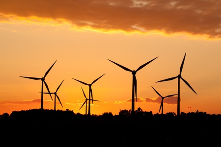 Silhouette of wind power station on sunsetの写真素材