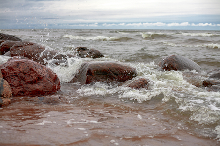 The stony sea coast in windy weatherの写真素材