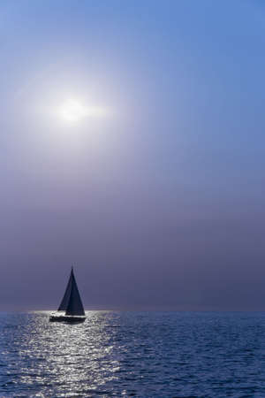 Sailboat silhuette sailing against a sunset 