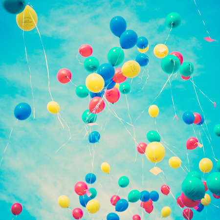 Colorful helium balloons in flightの写真素材