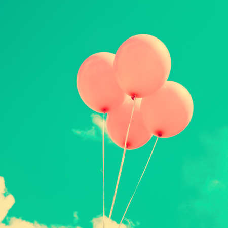 Pink vintage balloons over turquoise skyの写真素材